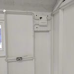 consumer unit on white board with conduit leading to lights and sockets