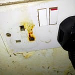 damaged socket faceplate with burning from appliance plug