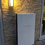pure drive battery storage installed on a stone wall house
